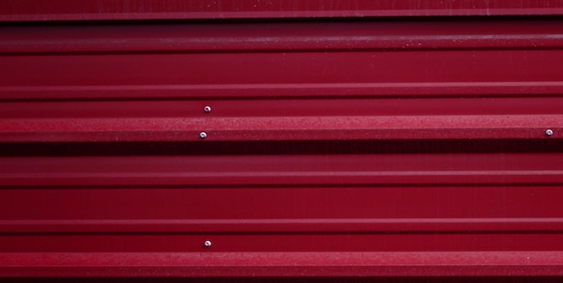 A red metal wall with the word steel on it.