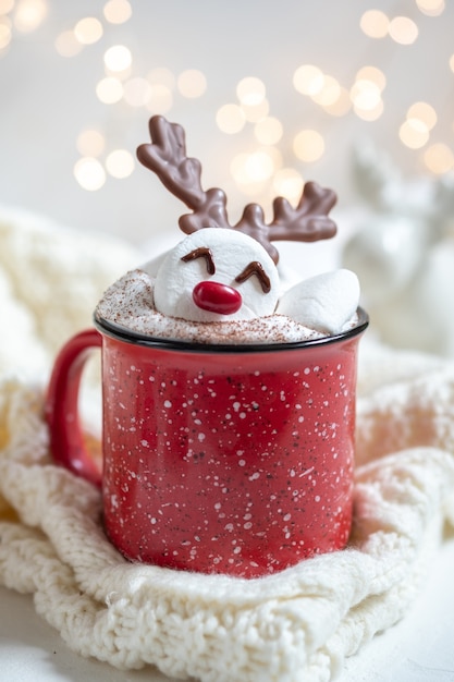 Red mug with hot chocolate and melted marshmallow