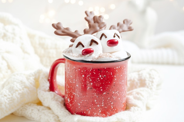 Red mug with hot chocolate and melted marshmallow