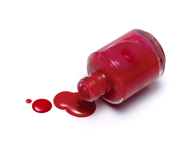 Red nail polish bottle isolated on white