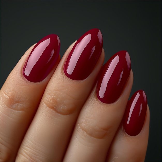 Red nail polish on manicured fingernails