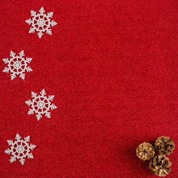 Red New Year's background with cones and snowflakes