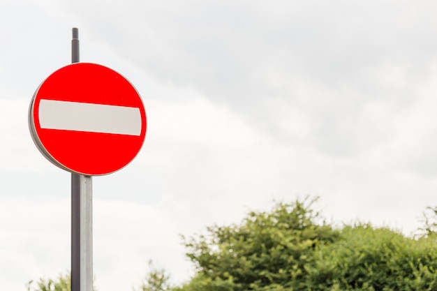 Red no entry traffic sign on metal pole