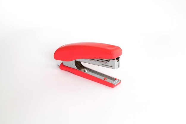 Red office stapler on an isolated white background