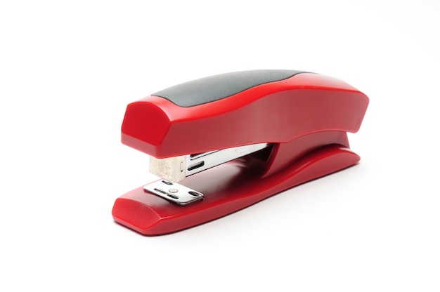 Red office stapler on white