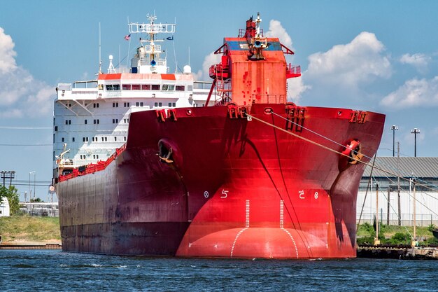 Red oil tanker ship prow view on sunny day