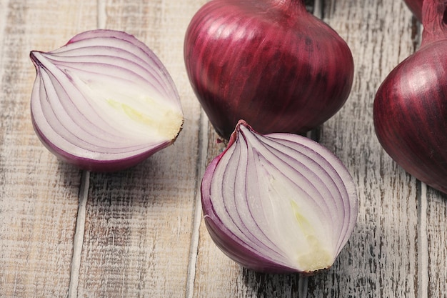 red onion bulbs on a wooden background