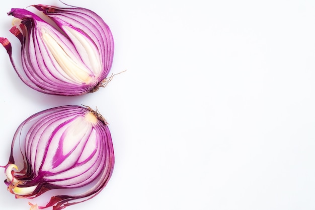 Red onion cut in half on a white background