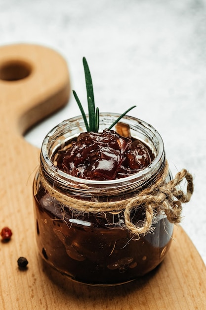 Red onion marmalade jam confiture in jar Vegetable jam on dark background Delicious sauce French cuisine Food recipe background space for text