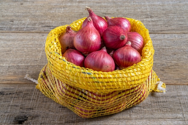 Red onion on shabby wooden board.