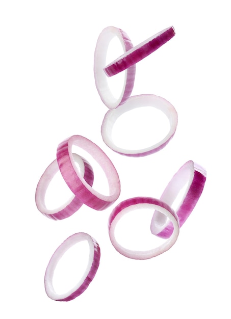 Red onion slices falling on white background