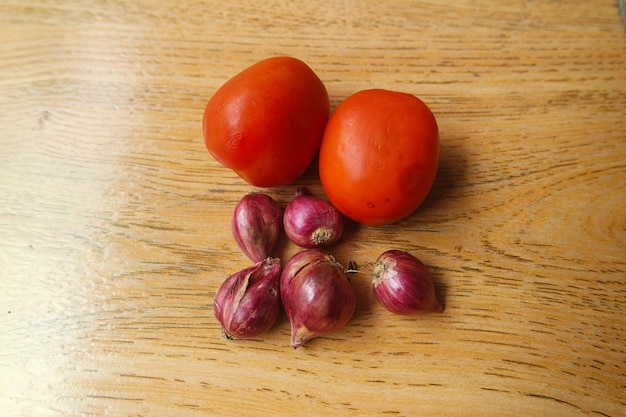 Red onions background on hand wooden hard background