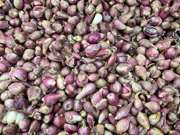 Red onions in plenty on display at local farmers market Big Red Onions Background