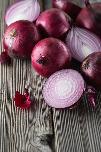 Red onions on rustic wooden table