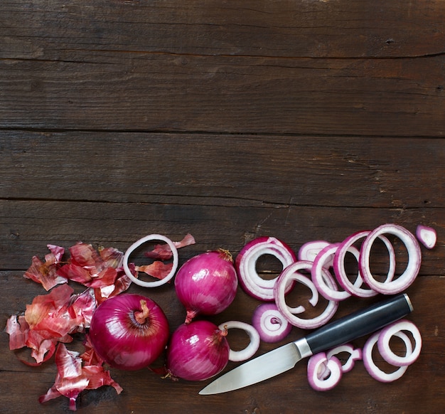 Red onions on a wooden table close up