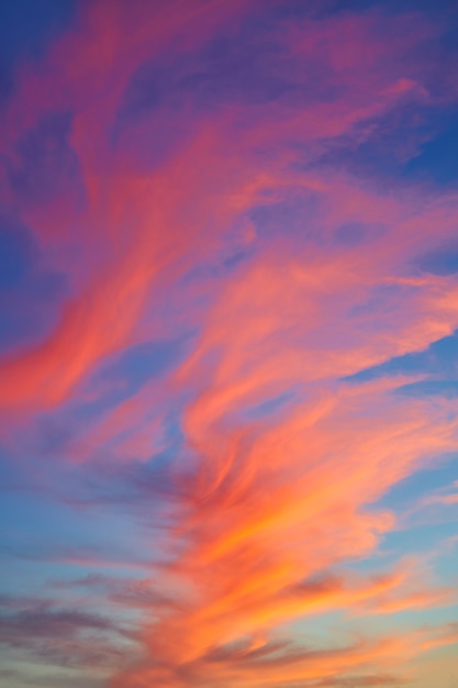 Red orange clouds at sunset over blue