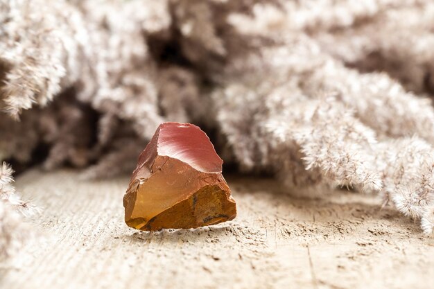 Red and Orange Flint Rock Specimen on Wood