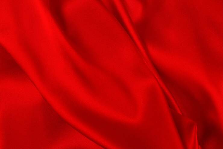 Photo red and orange silk or satin luxury fabric texture can use as abstract background.
