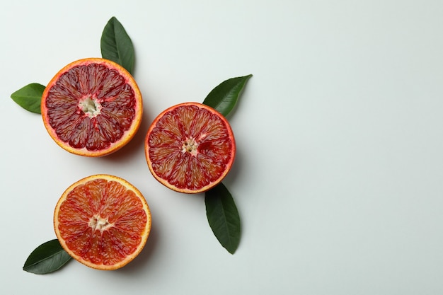 Red orange slices with leaves on white