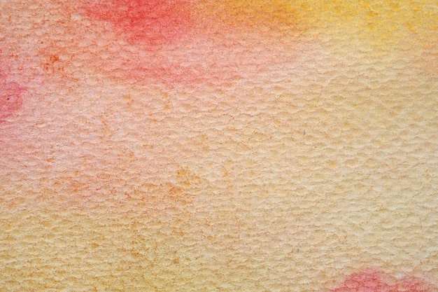 Red, orange, yellow abstract watercolor painting textured on white paper background