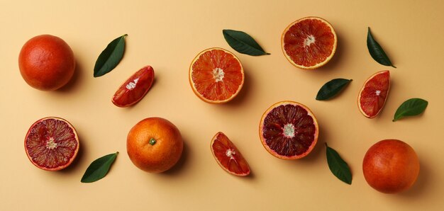 Red oranges and leaves on beige isolated background