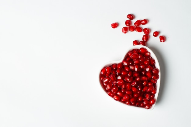 Red organic tasty pomegranate seeds with love