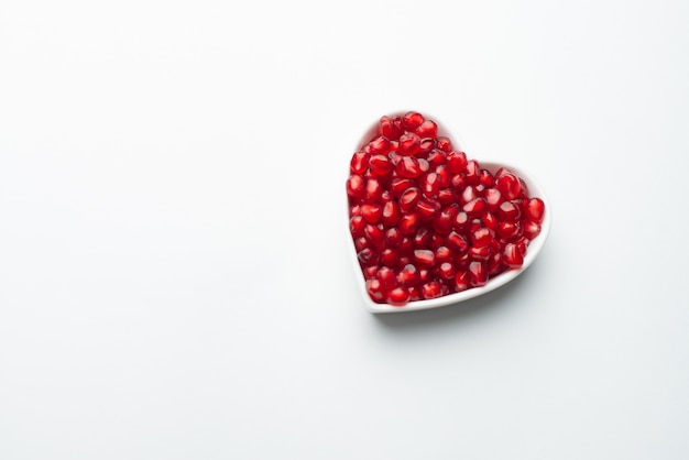 Red organic tasty pomegranate seeds with love