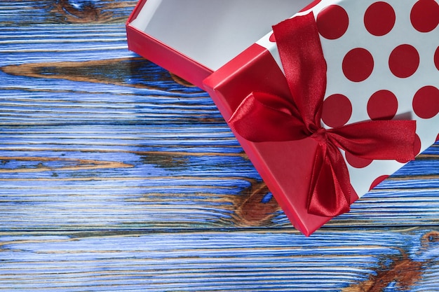 Red packed gift box on vintage wooden board