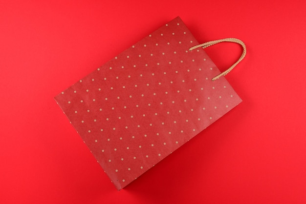 Red packet with polka dots on a red background. copy\
space.