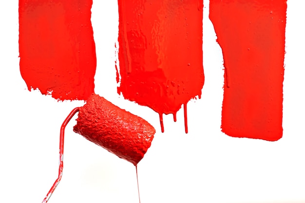 Photo red paint dripping with paint roller