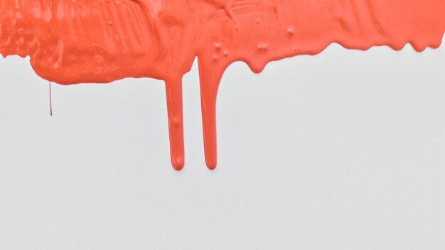 Photo red paint spreads on a white background copy space