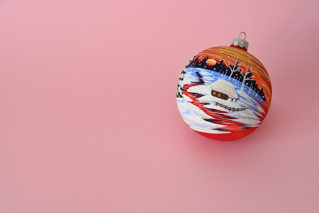 red painted christmas sphere isolated on pink background