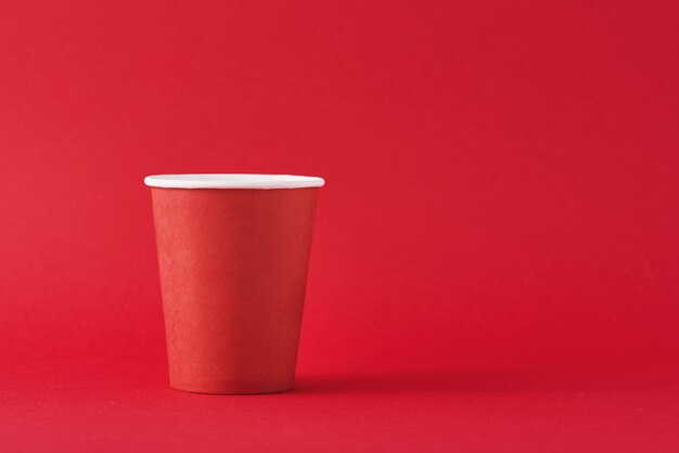 Premium Photo  Mockup of red disposable cups on black background with  reflection and space for text