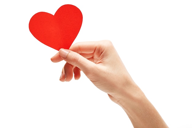 red paper heart in hand isolated on white