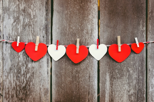 Red paper heart hanging on the clothesline