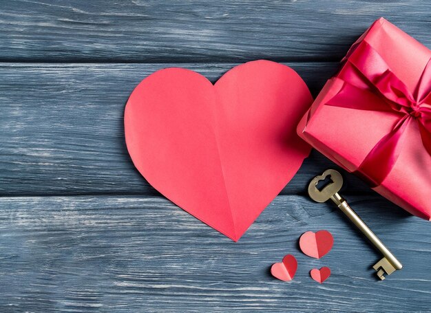 Red paper heart and old key on a dark wooden background Valentine39s Day Copy space