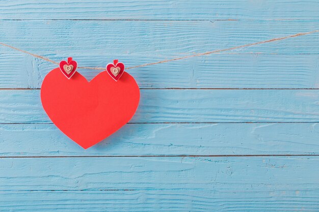 Red paper heart on old wooden background