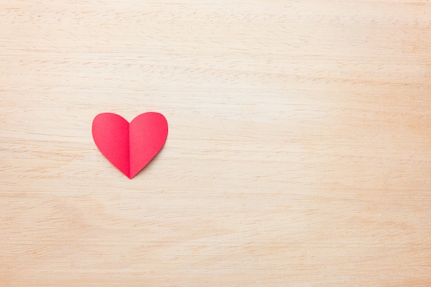 Red paper heart on wooden background, love and valentine concept