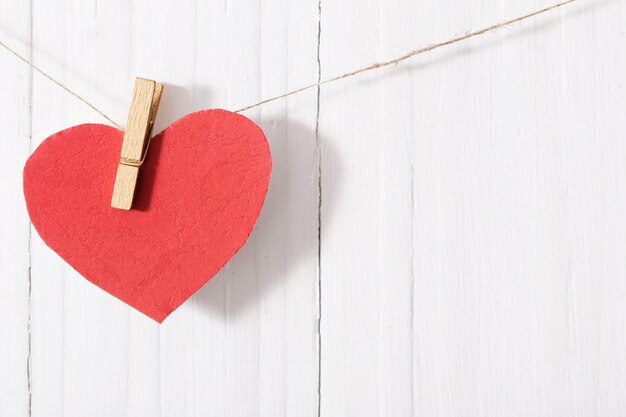 Red paper heart on wooden table