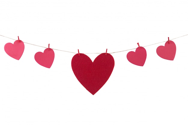 Photo red paper hearts hanging on the clothesline