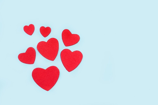 Red paper hearts on a light blue background