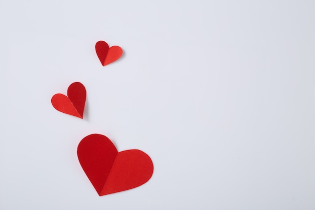 Red paper hearts on white table