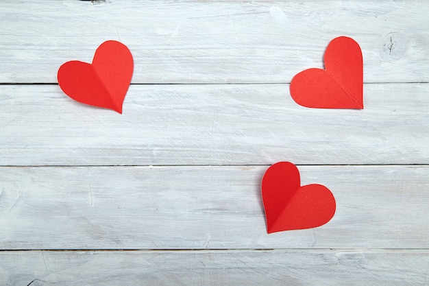 Red paper hearts on white wood Valentine's Day