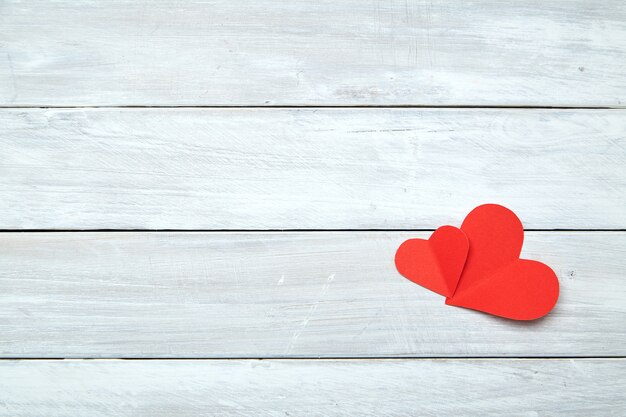 Red paper hearts on white wood Valentine's Day