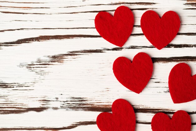 Red paper hearts on wooden close up