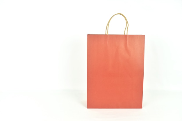 Photo red paper shopping bags on white background with copy space