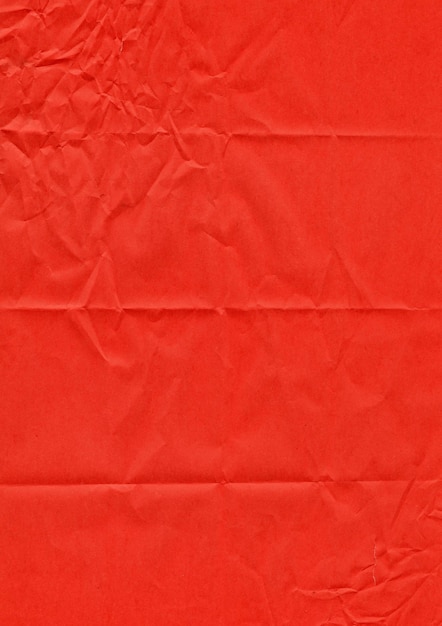 Red paper texture with crumpled edges and wrinkles