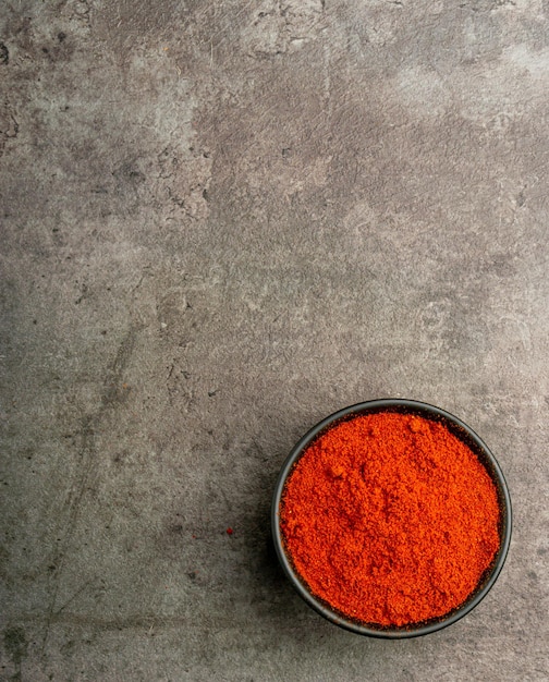 Red Paprika Powder from a flatlay angle with a dramatic dark background