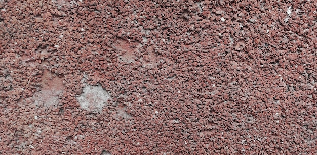 Red pebble textured wall background