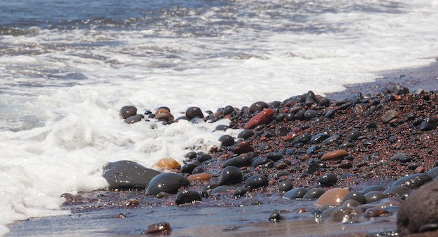 Red pebbles of the typical red beach of Santorini